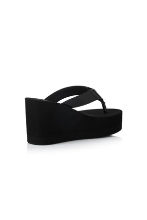 Lulu Sandal by Alias Mae, a bold black leather wedge with 9cm lift and clean silhouette. Perfect for elevated everyday or evening wear.