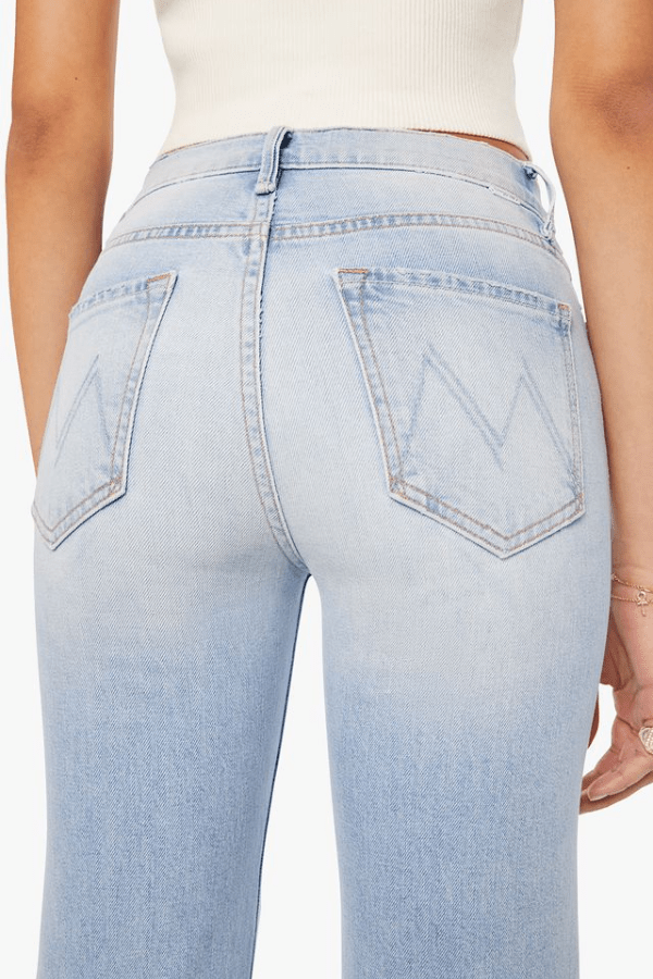 The Kick It Go Long by MOTHER, high-rise straight jeans in light blue semi-rigid denim with fading. Perfect for everyday vintage-inspired style.