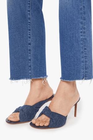 The Mid Rise Rambler Zip Ankle Fray Dugout Doobies by MOTHER, stretch denim jeans with vintage fade and frayed hem. Perfect for off-duty days.