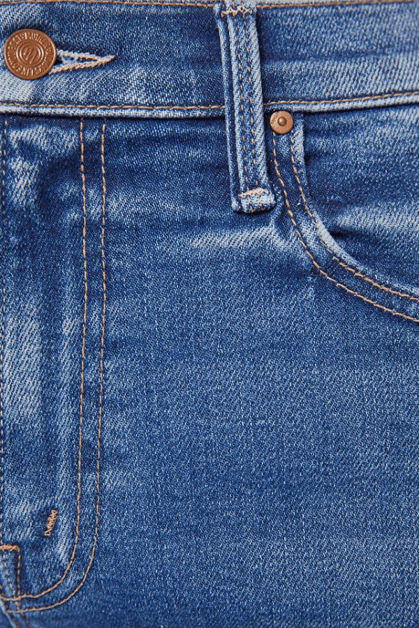 The Mid Rise Rambler Zip Ankle Fray Dugout Doobies by MOTHER, stretch denim jeans with vintage fade and frayed hem. Perfect for off-duty days.