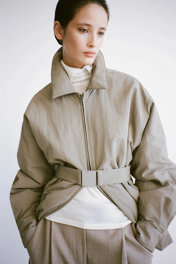 Manon Padded Belted Jacket Clay by camilla and marc – hammered texture belted puffer jacket with utility buckle.