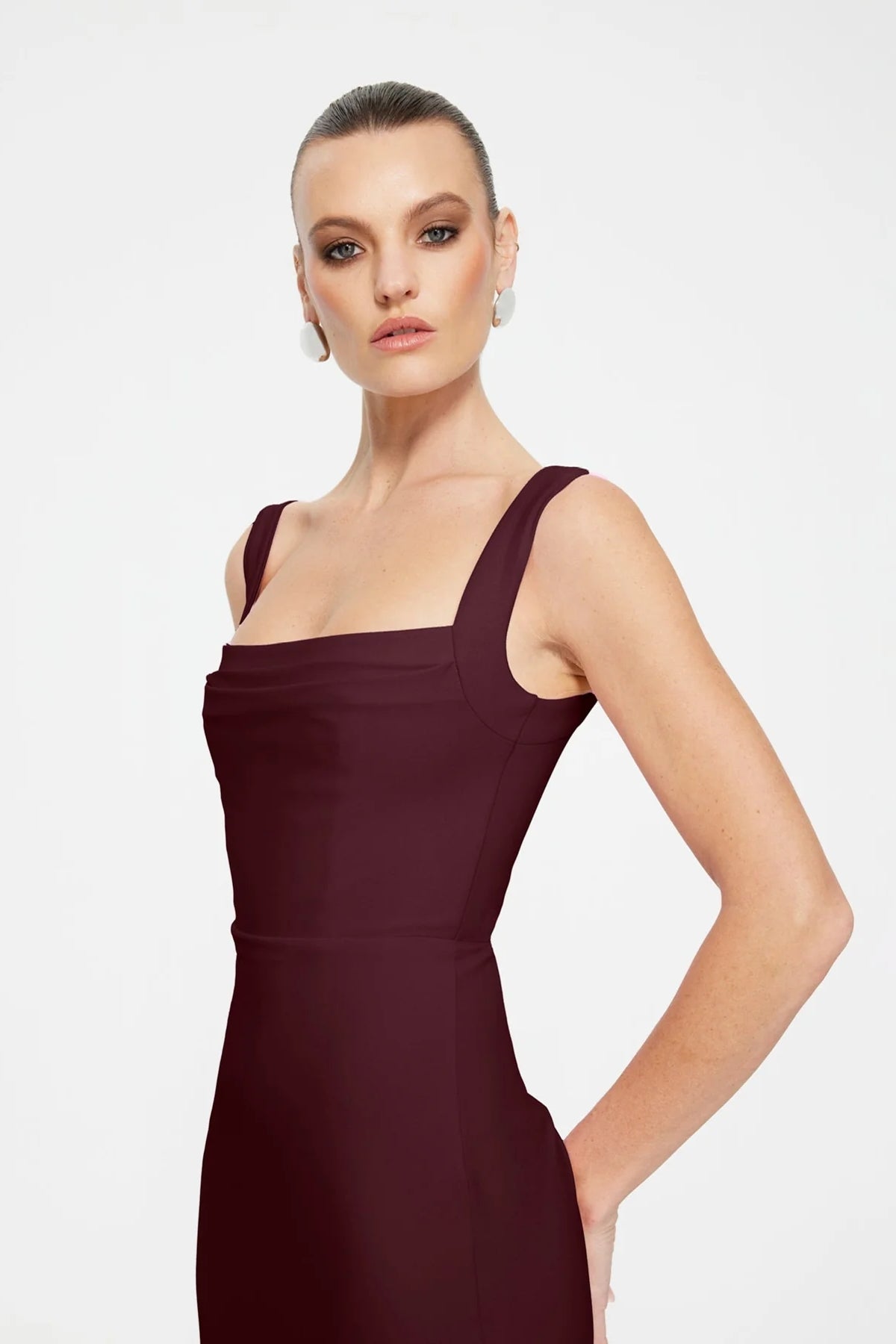 Marbella Gown in Wine by Effie Kats, a bustier-inspired floor-length gown with square neckline, ruched bodice, and figure-flattering stretch crepe.