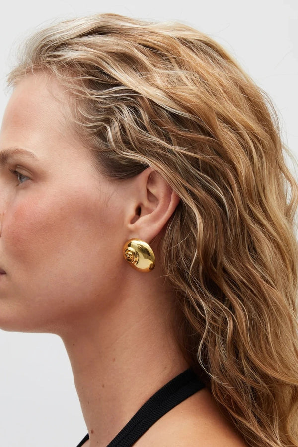 Mare Earrings Gold by Heaven Mayhem – shell inspired gold earrings with rounded sculptural silhouette.