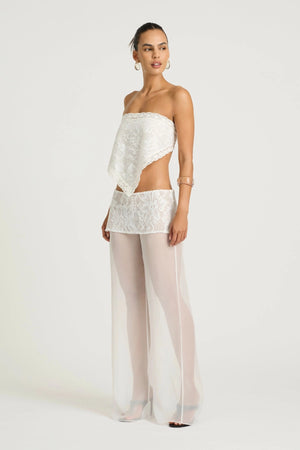 Marley Crochet Pant Cream by Benni, a sheer wide-leg pant with wrap lace mini skirt for a bold, elevated summer look.

