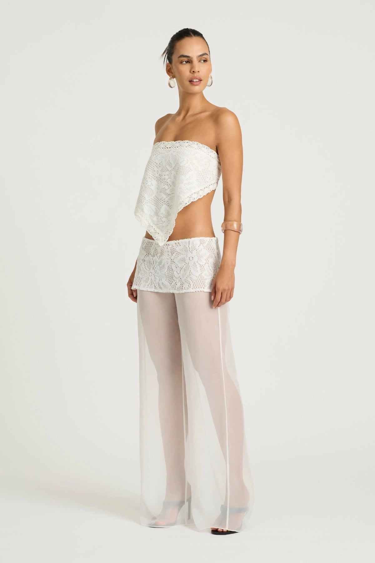 Marley Crochet Pant Cream by Benni, a sheer wide-leg pant with wrap lace mini skirt for a bold, elevated summer look.
