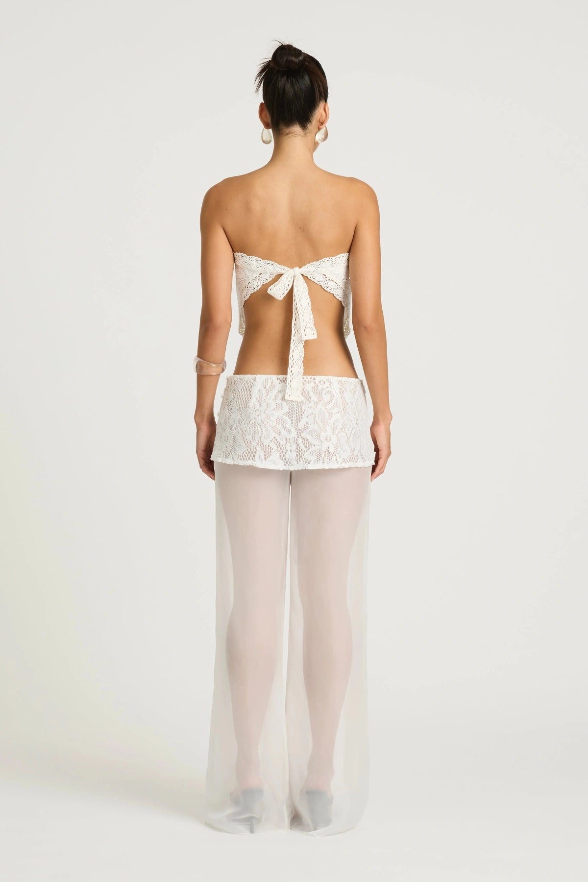 Marley Crochet Pant Cream by Benni, a sheer wide-leg pant with wrap lace mini skirt for a bold, elevated summer look.
