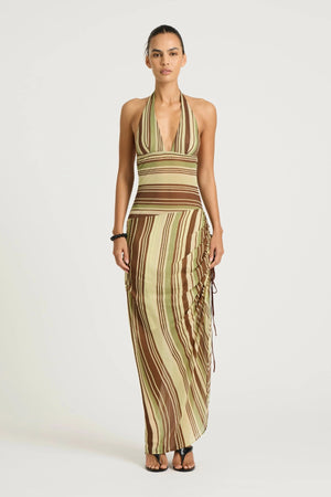 Marnie Maxi Dress Earth Stripe by Benni, a plunge halter maxi with draped skirt and adjustable side ruching for a flattering fit.
