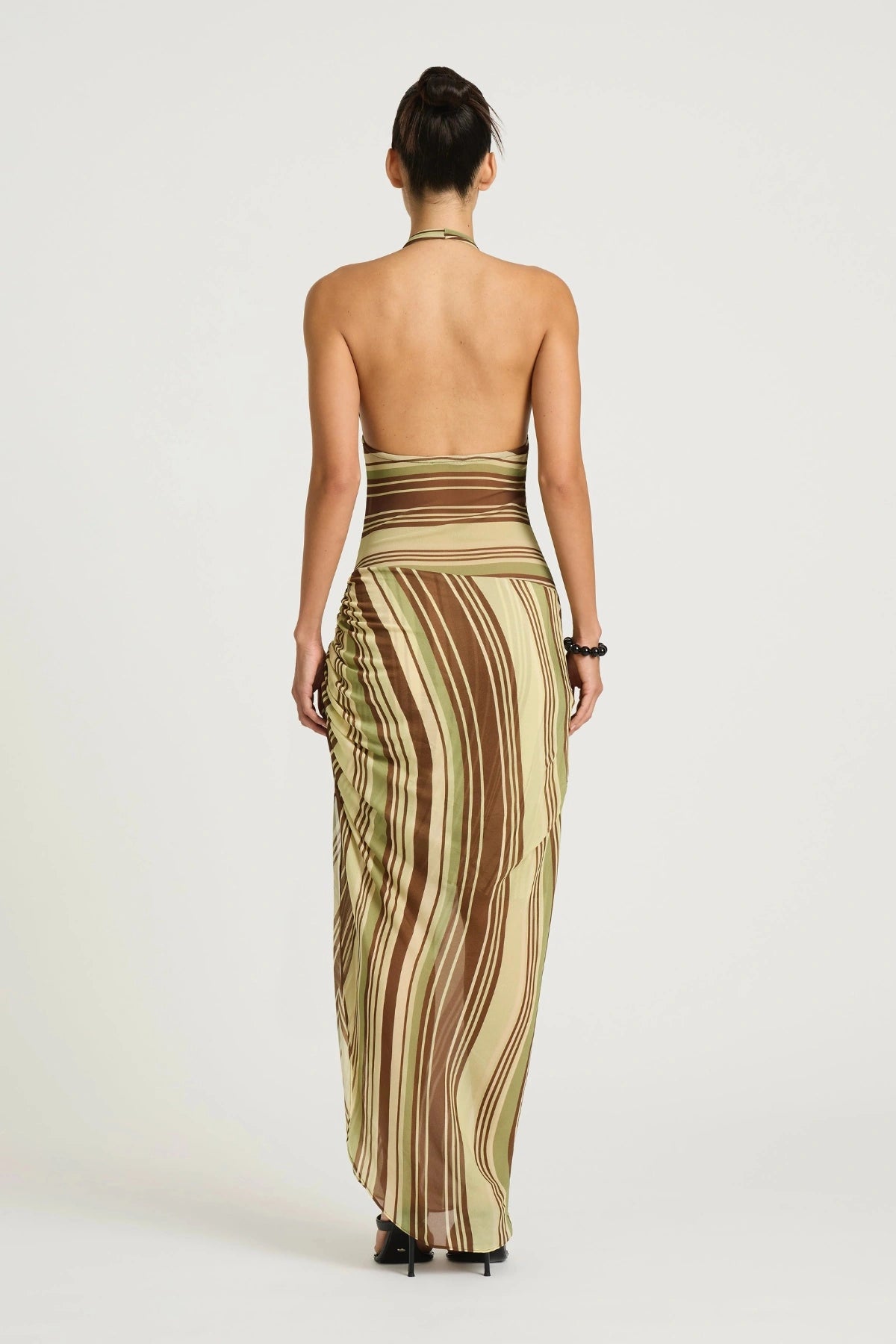 Marnie Maxi Dress Earth Stripe by Benni, a plunge halter maxi with draped skirt and adjustable side ruching for a flattering fit.
