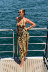Marnie Maxi Dress Earth Stripe by Benni, a plunge halter maxi with draped skirt and adjustable side ruching for a flattering fit.

