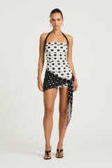 Marnie Mini Dress by Benni, black and white polka halter mini with straight neckline, ruched bodice and scarf wrap tie detail.