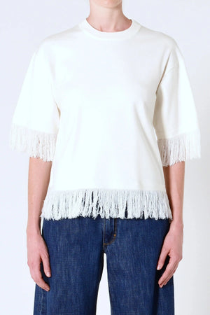 Marrakech Fringe Knit in White by Neuw Denim, a sleeveless relaxed knit with fringe hem. Perfect for layering with denim or linen.
