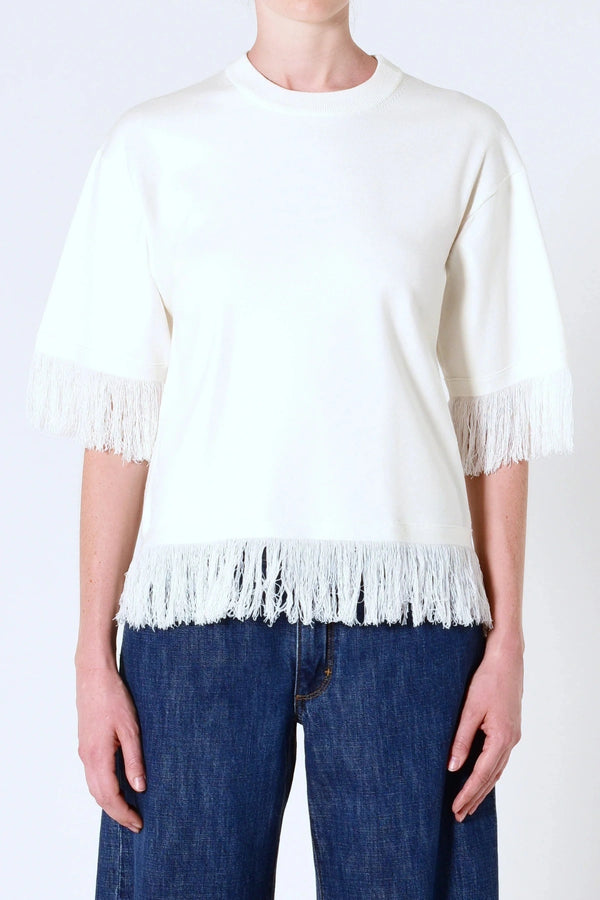 Marrakech Fringe Knit in White by Neuw Denim, a sleeveless relaxed knit with fringe hem. Perfect for layering with denim or linen.
