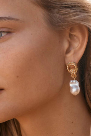 Mirage Earrings by Amber Sceats - gold statement earrings with freshwater pearls and sculptural knot detail, designed for elevated styling.
