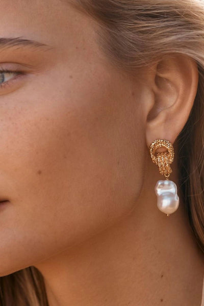 Mirage Earrings by Amber Sceats - gold statement earrings with freshwater pearls and sculptural knot detail, designed for elevated styling.