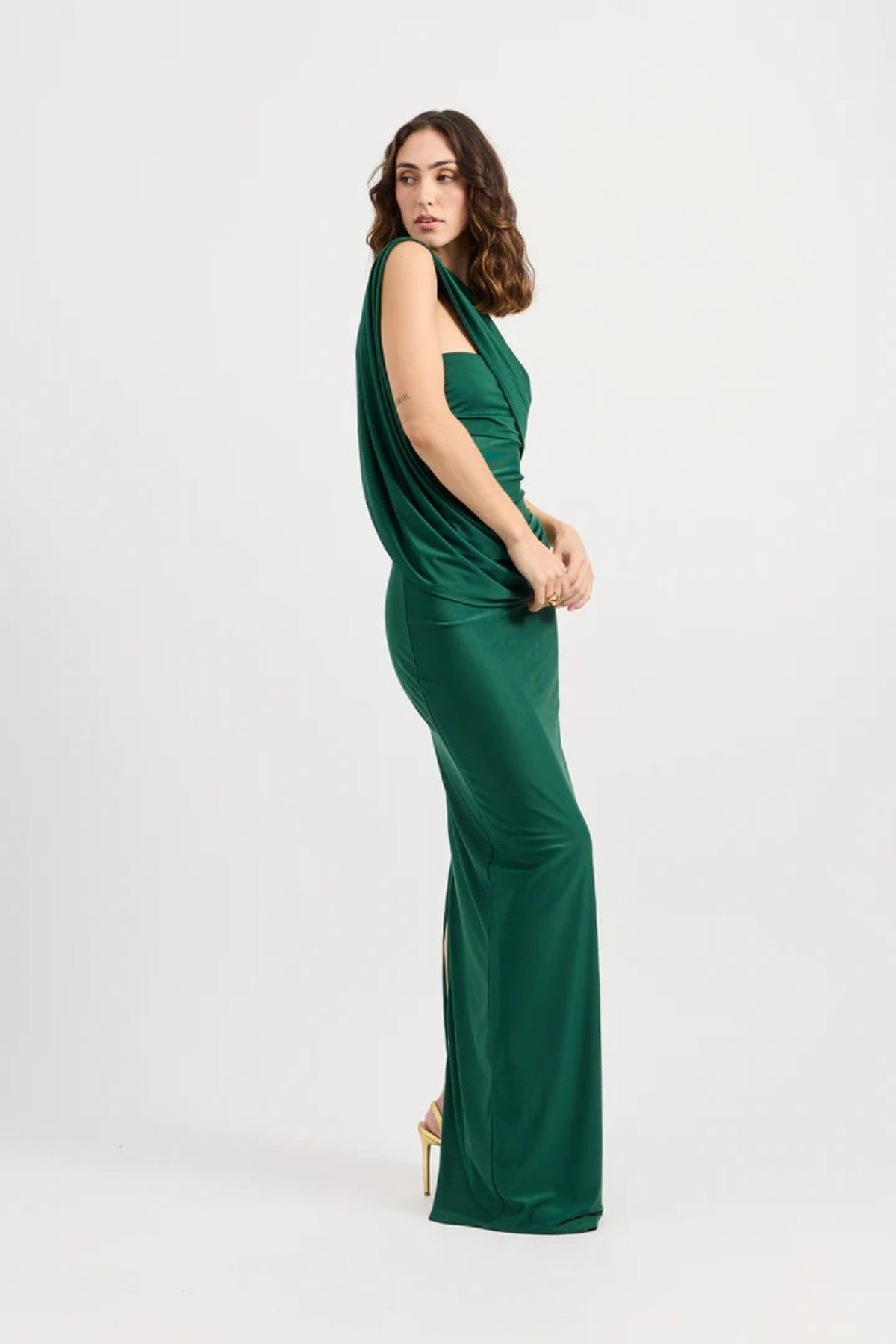 Mojave Dress Emerald by Tojhà — an emerald strapless maxi with sculptural draping and a gold buckle, perfect for elegant occasions.