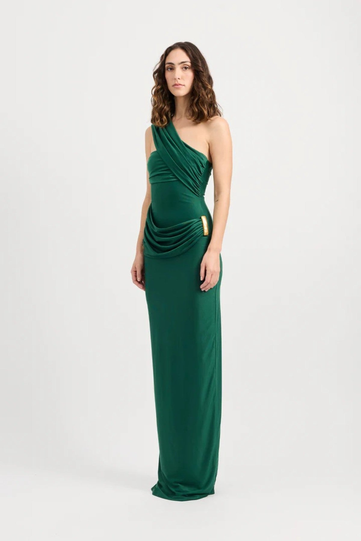 Mojave Dress Emerald by Tojhà — an emerald strapless maxi with sculptural draping and a gold buckle, perfect for elegant occasions.