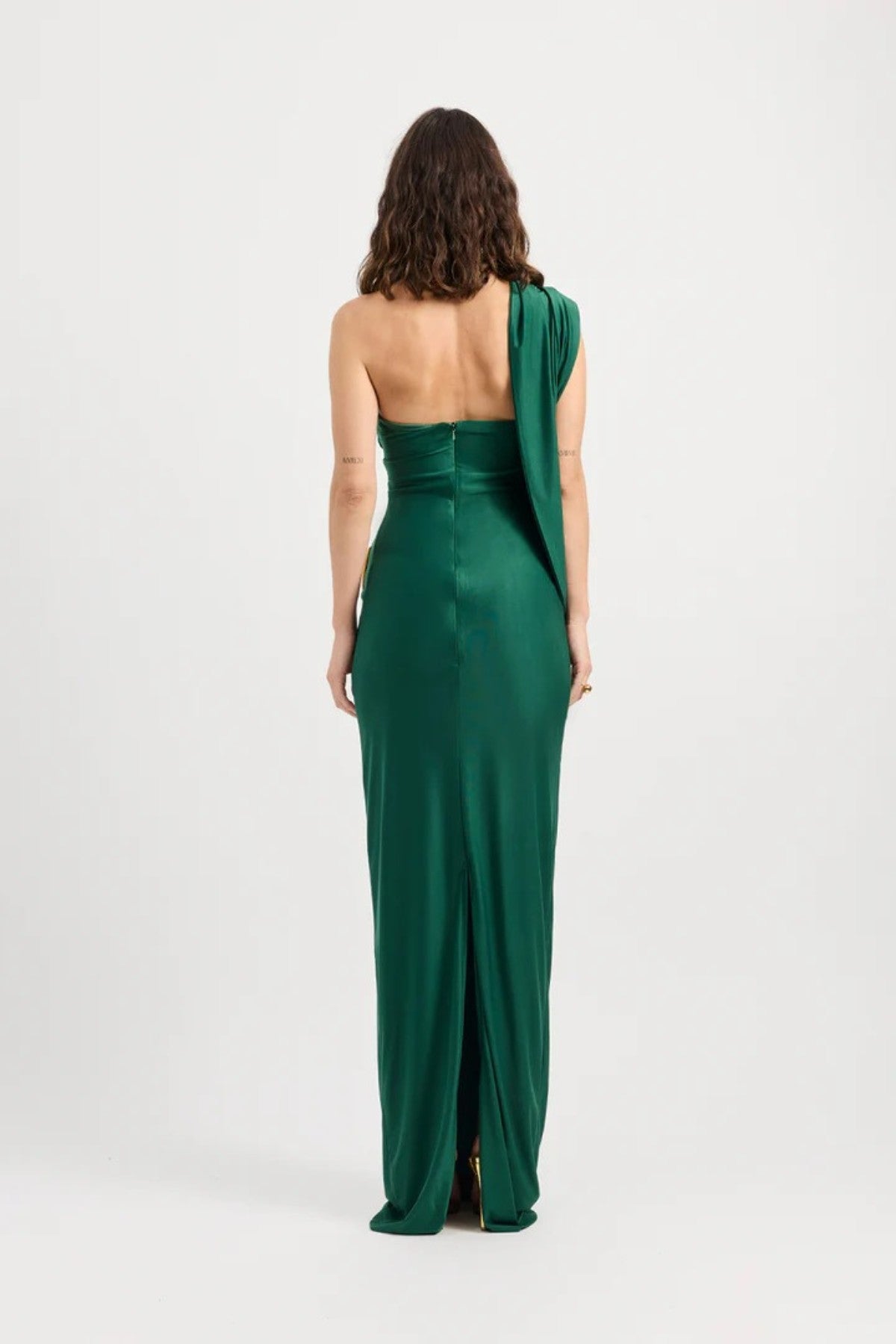 Mojave Dress Emerald by Tojhà — an emerald strapless maxi with sculptural draping and a gold buckle, perfect for elegant occasions.
