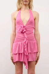 Monica Dress in Fucsia by DŽO, a ruched power mesh mini with plunging halter neckline, floral appliqué, and tiered layers.