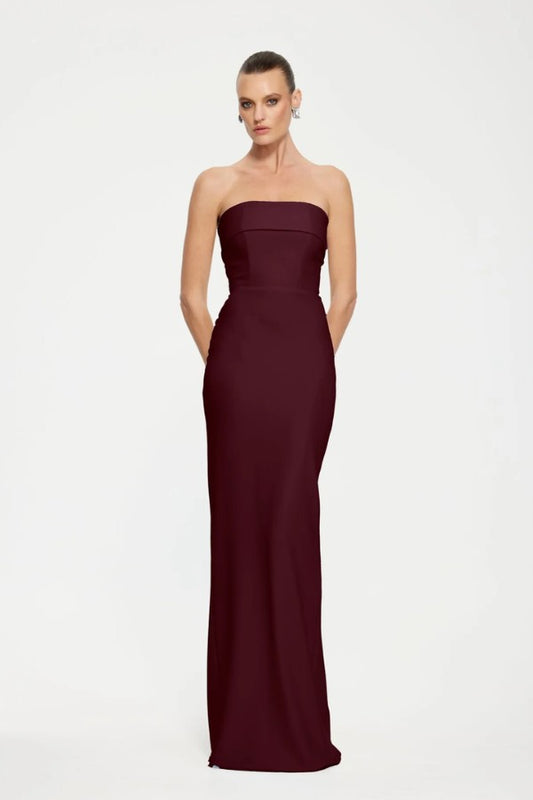 Monroe Gown in Wine by Effie Kats, a strapless floor-length gown in stretch crepe with folded bodice panel and back split for elegant evening wear.