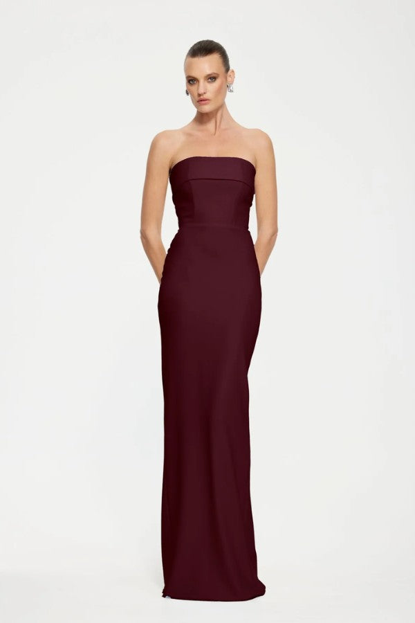 Monroe Gown in Wine by Effie Kats, a strapless floor-length gown in stretch crepe with folded bodice panel and back split for elegant evening wear.