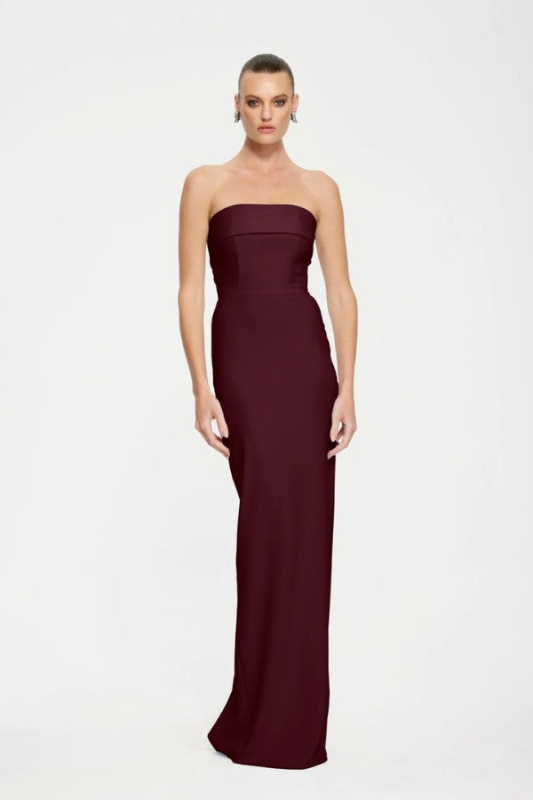 Monroe Gown in Wine by Effie Kats, a strapless floor-length gown in stretch crepe with folded bodice panel and back split for elegant evening wear.