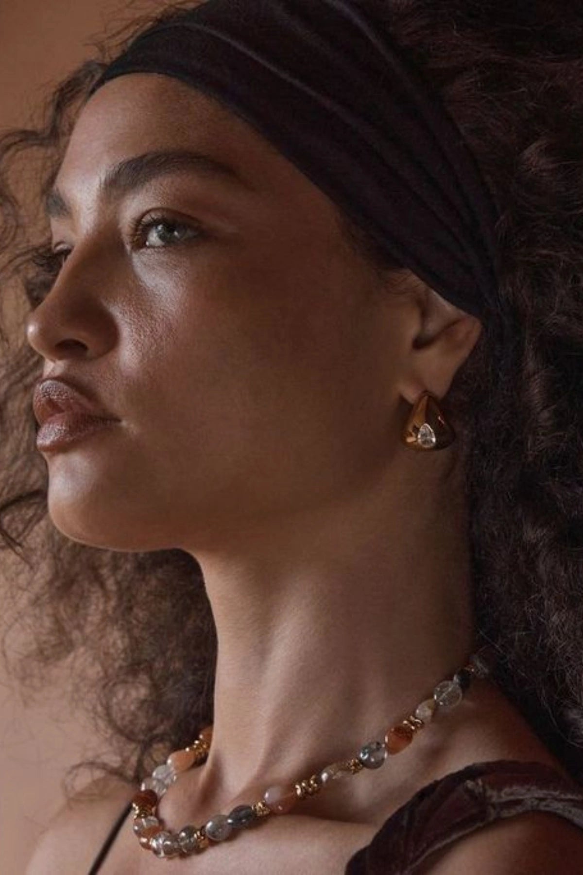 Monterosso Earrings Gold by Amber Sceats, polished curved hoops with cubic zirconia detail, a trendy piece perfect for everyday wear or chic evenings.