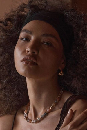 Monterosso Earrings Gold by Amber Sceats, polished curved hoops with cubic zirconia detail, a trendy piece perfect for everyday wear or chic evenings.