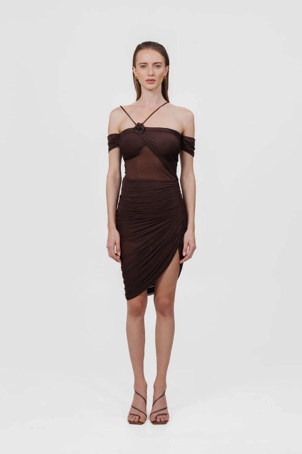 Moreno Dress in Wood by Maygel Coronel, a ruched off-shoulder mini with sheer panelling and floral detail. Perfect for summer events.
