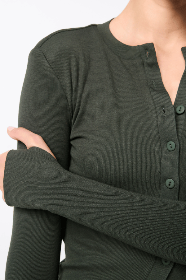 Lyon Cardigan by Mossman, a fitted ribbed knit in moss green with thumb hole sleeves and button front. Perfect for layering year-round.