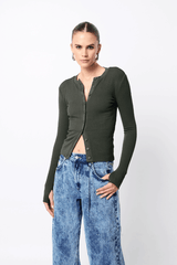 Lyon Cardigan by Mossman, a fitted ribbed knit in moss green with thumb hole sleeves and button front. Perfect for layering year-round.