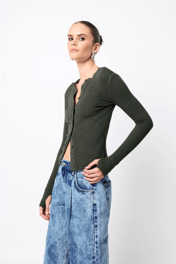 Lyon Cardigan by Mossman, a fitted ribbed knit in moss green with thumb hole sleeves and button front. Perfect for layering year-round.