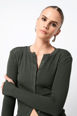 Lyon Cardigan by Mossman, a fitted ribbed knit in moss green with thumb hole sleeves and button front. Perfect for layering year-round.