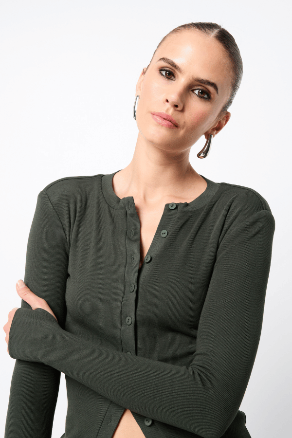 Lyon Cardigan by Mossman, a fitted ribbed knit in moss green with thumb hole sleeves and button front. Perfect for layering year-round.