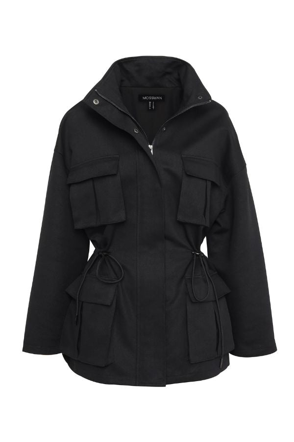 Mossman My Muse Anorak in Black, a modern utility jacket featuring oversized flap pockets, adjustable drawstring waist, and a concealed zip front for an elevated off-duty look.