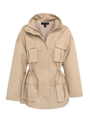Mossman My Muse Anorak in Natural, a timeless utility jacket with oversized flap pockets, adjustable drawstring waist, and a concealed zip front for effortless layering.
