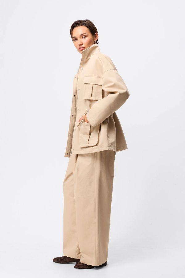 Mossman My Muse Anorak in Natural, a timeless utility jacket with oversized flap pockets, adjustable drawstring waist, and a concealed zip front for effortless layering.