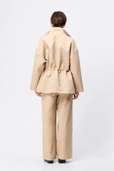 Mossman My Muse Anorak in Natural, a timeless utility jacket with oversized flap pockets, adjustable drawstring waist, and a concealed zip front for effortless layering.