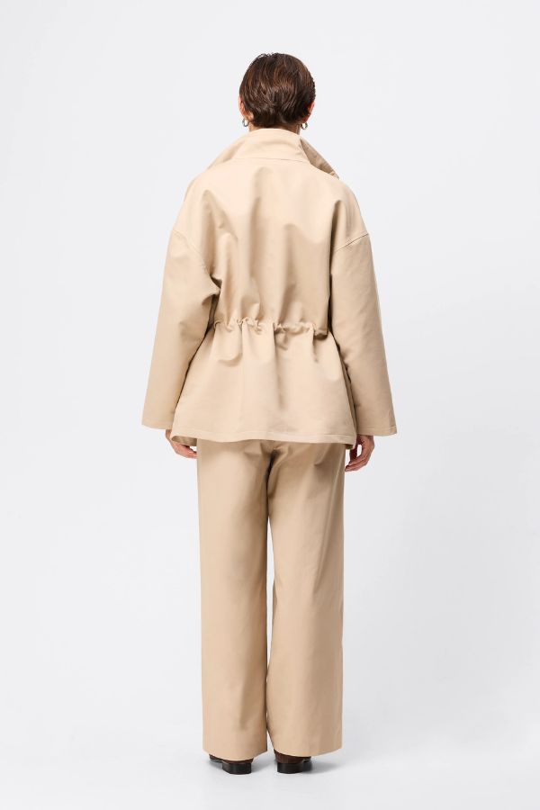 Mossman My Muse Anorak in Natural, a timeless utility jacket with oversized flap pockets, adjustable drawstring waist, and a concealed zip front for effortless layering.