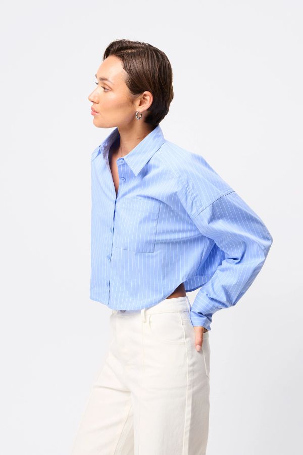 Mossman Repeat After Me Cropped Shirt in Blue Stripe, a chic cropped button-up with crisp white stripes, patch pockets, and extended cuffs for elevated everyday style.
