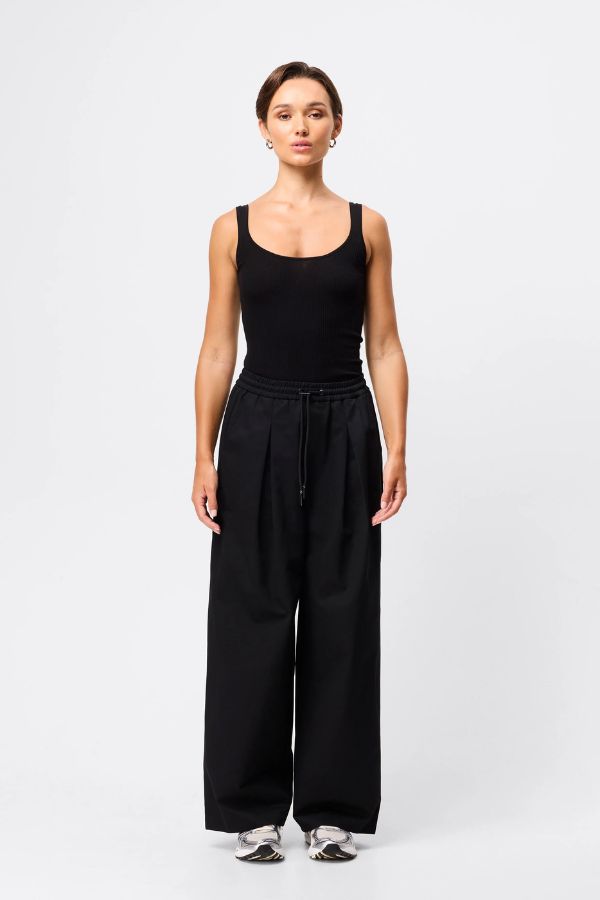 Mossman Tied Down Pant in Black, a wide-leg cotton pant featuring an elasticated waistband with adjustable toggle and functional pockets for chic utility style.