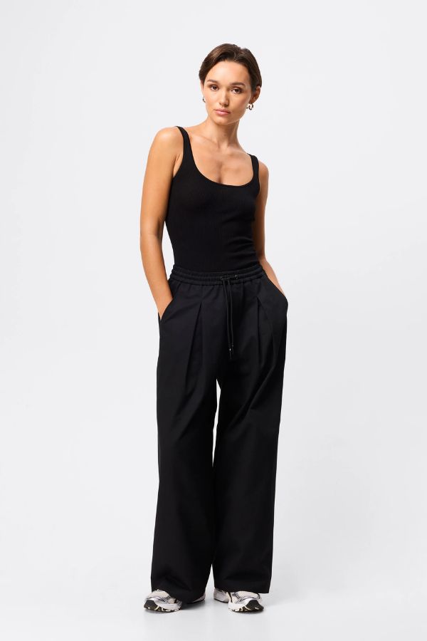 Mossman Tied Down Pant in Black, a wide-leg cotton pant featuring an elasticated waistband with adjustable toggle and functional pockets for chic utility style.