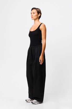 Mossman Tied Down Pant in Black, a wide-leg cotton pant featuring an elasticated waistband with adjustable toggle and functional pockets for chic utility style.