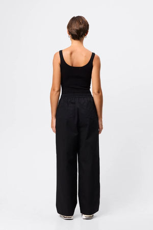 Mossman Tied Down Pant in Black, a wide-leg cotton pant featuring an elasticated waistband with adjustable toggle and functional pockets for chic utility style.