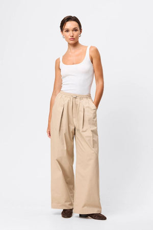 Mossman Tied Down Pant in Natural, a relaxed wide-leg cotton pant featuring an elasticated waistband with adjustable toggle and functional pockets for versatile everyday style.