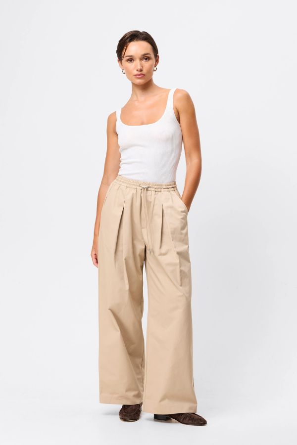 Mossman Tied Down Pant in Natural, a relaxed wide-leg cotton pant featuring an elasticated waistband with adjustable toggle and functional pockets for versatile everyday style.