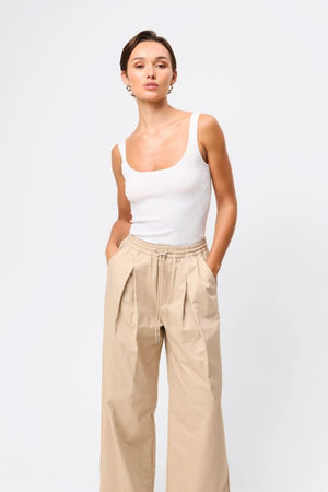 Mossman Tied Down Pant in Natural, a relaxed wide-leg cotton pant featuring an elasticated waistband with adjustable toggle and functional pockets for versatile everyday style. 3 