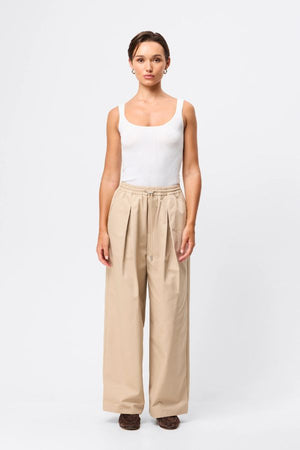 Mossman Tied Down Pant in Natural, a relaxed wide-leg cotton pant featuring an elasticated waistband with adjustable toggle and functional pockets for versatile everyday style. 5 