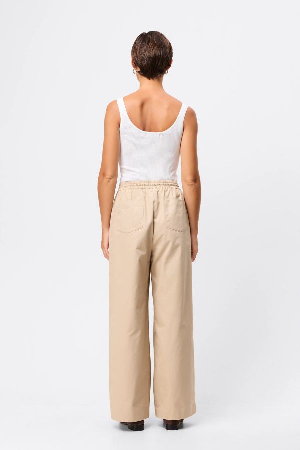 Mossman Tied Down Pant in Natural, a relaxed wide-leg cotton pant featuring an elasticated waistband with adjustable toggle and functional pockets for versatile everyday style.