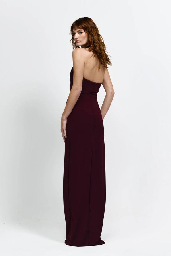 Myla Gown in Wine by Effie Kats, a deep scoop floor-length gown with open back, thigh-high split, and figure-hugging stretch fabric.