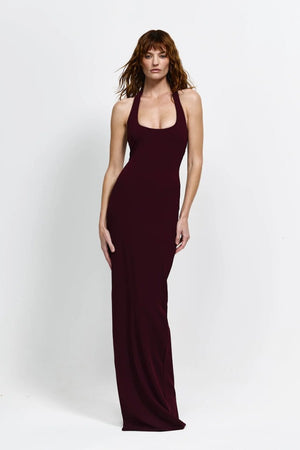 Myla Gown in Wine by Effie Kats, a deep scoop floor-length gown with open back, thigh-high split, and figure-hugging stretch fabric.